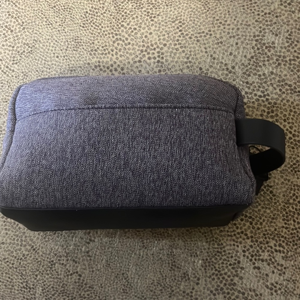Bespoke  water resistant dopp kit in gray outside pocket and aqua color zipper